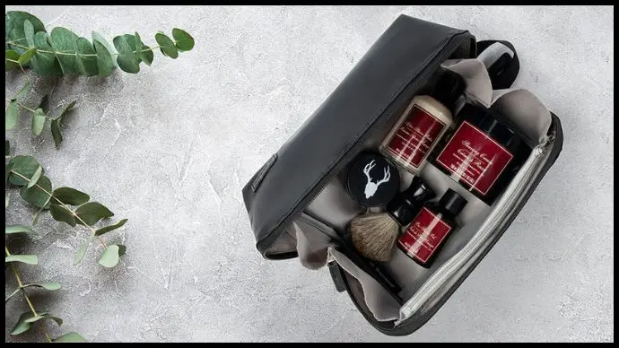 Leather Dopp kit with toiletries for travel, showing organization compartments