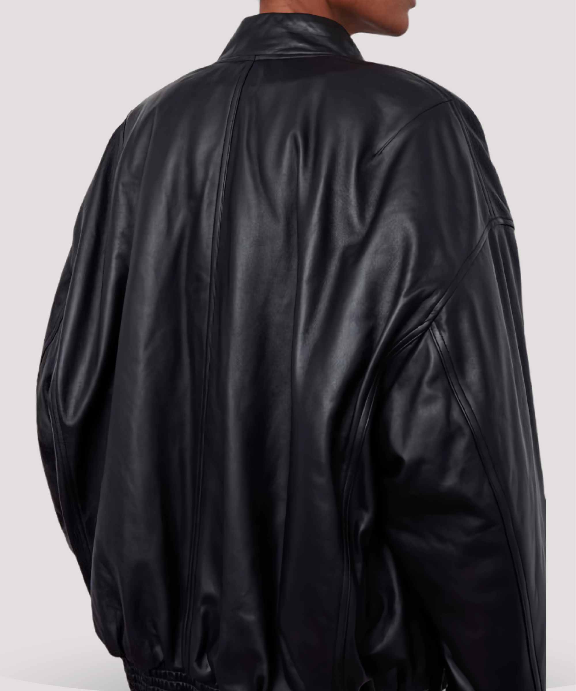 Flat-lay-of-black-leather-bomber-jacket-women-love-Selena-Gomez-inspired-design-with-zip-closure-snap-pockets-and-buttery-lambskin-finish