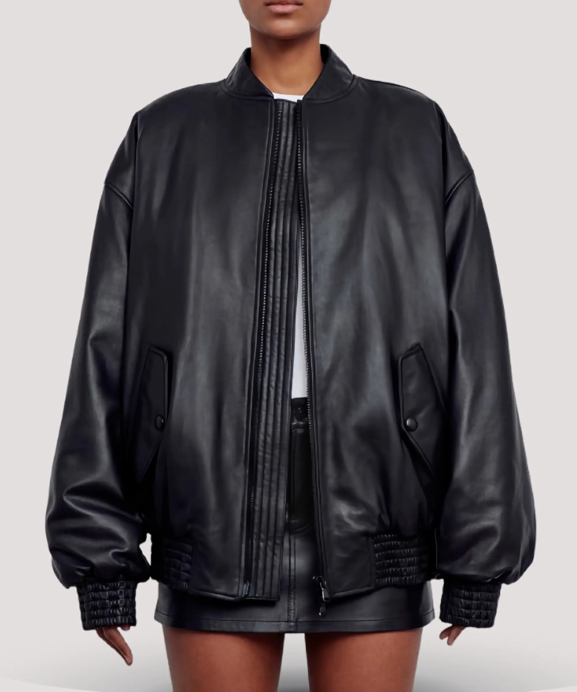 Selena-Gomez-style-black-leather-bomber-jacket-for-women-hanging-on-wooden-hanger-classic-bomber-silhouette-with-polished-silver-zipper-and-soft-lining
