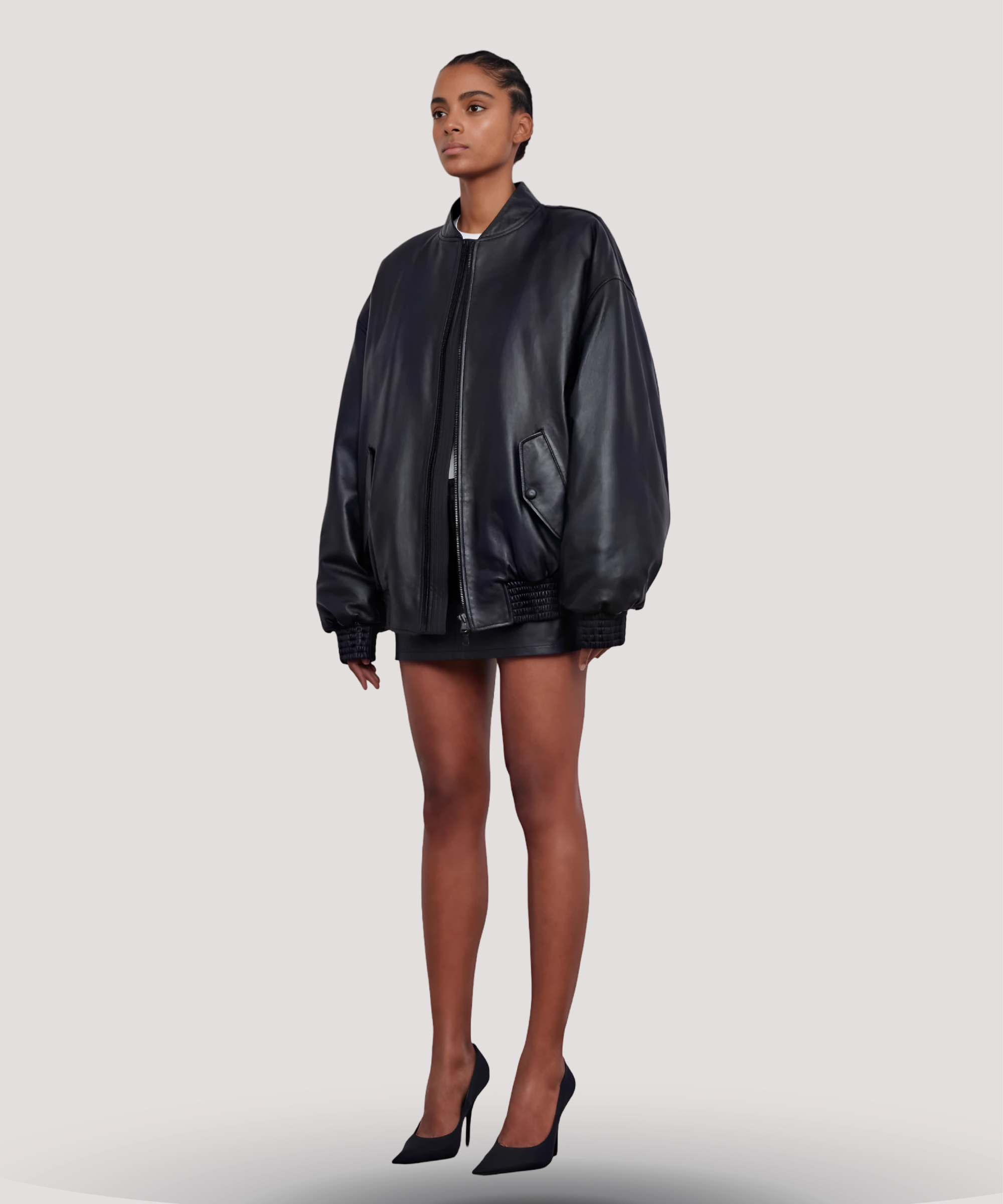 Side-profile-of-womens-black-leather-bomber-jacket-inspired-by-Selena-Gomez-showing-clean-shoulder-seams-cropped-hem-and-flattering-oversized-fit