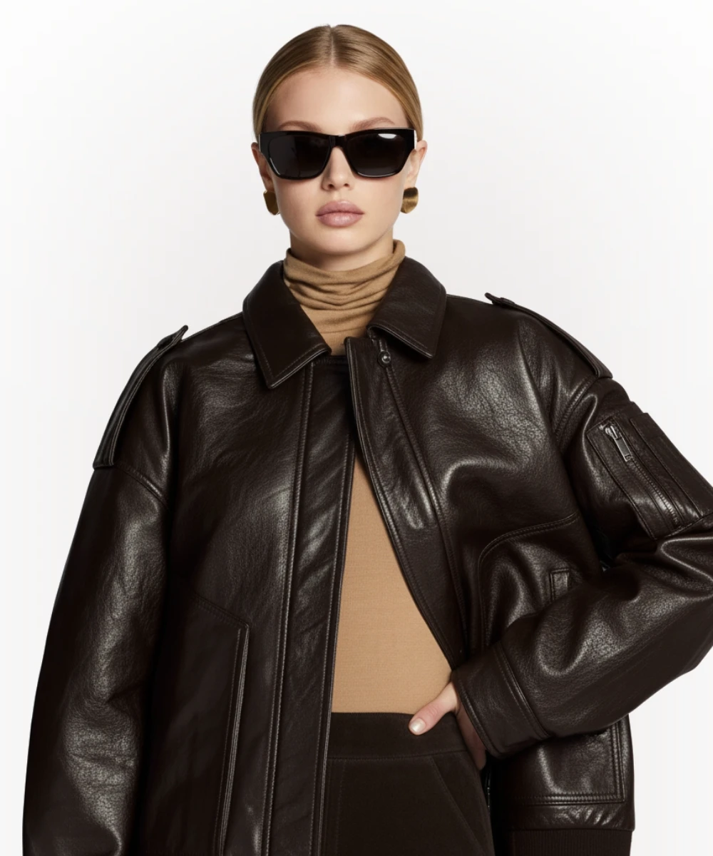 Woman wearing brown vintage leather bomber jacket front view