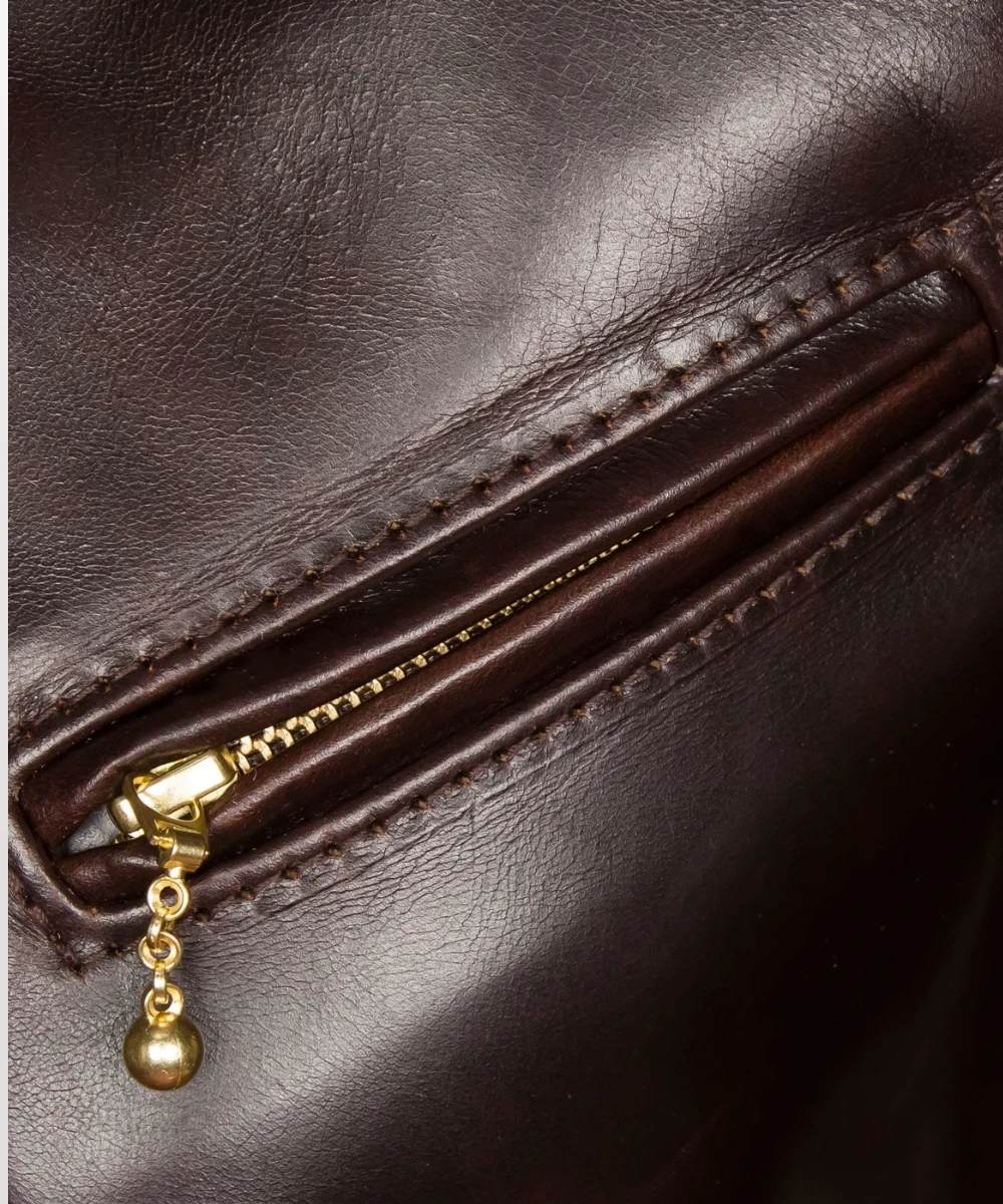 Interior view of 1930s half belt leather jacket showing soft moleskin pocket lining and brass zipper.