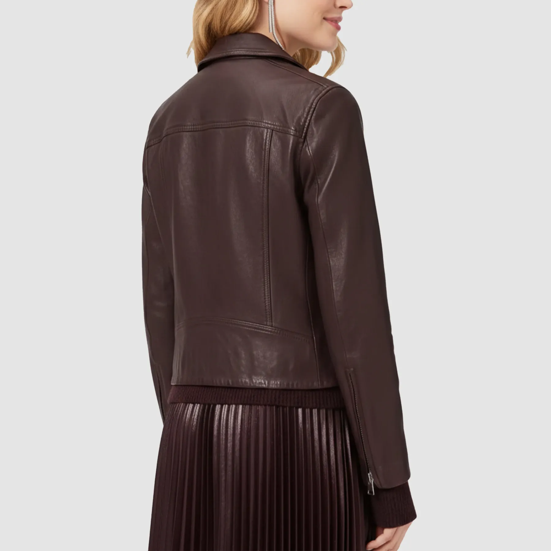 Oxblood leather biker jacket hanging on wooden hanger showing sleek biker design.