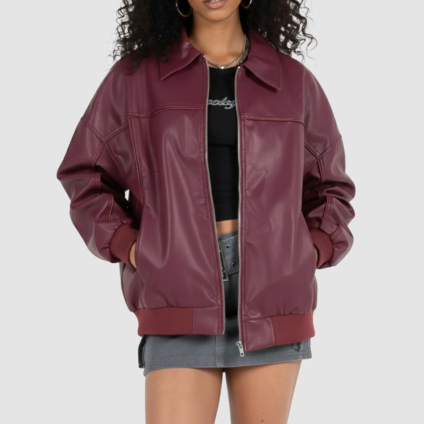 Women’s maroon leather bomber jacket shown from the front with ribbed cuffs and zip closure.