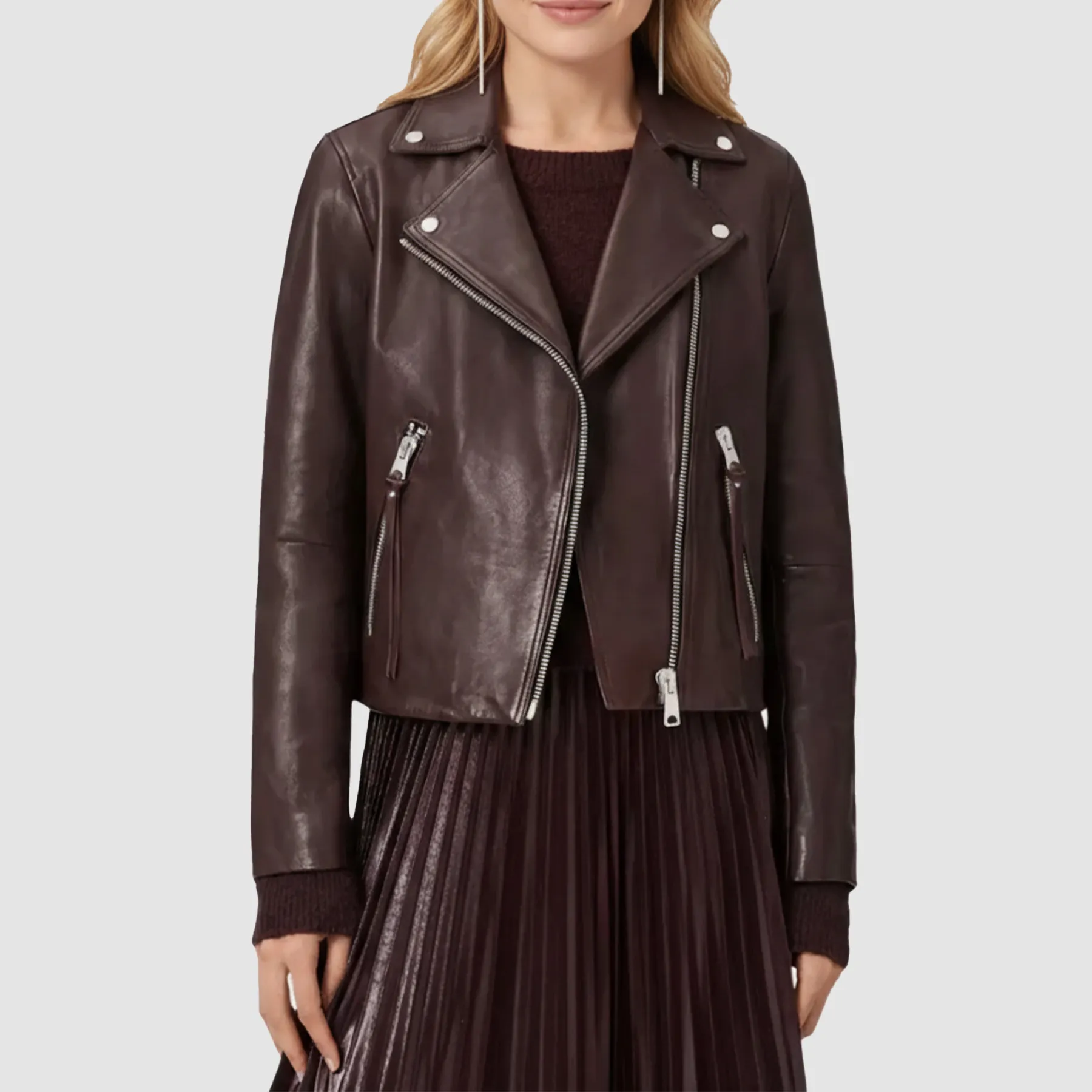 Woman wearing an oxblood leather biker jacket with zip details and slim fit style.