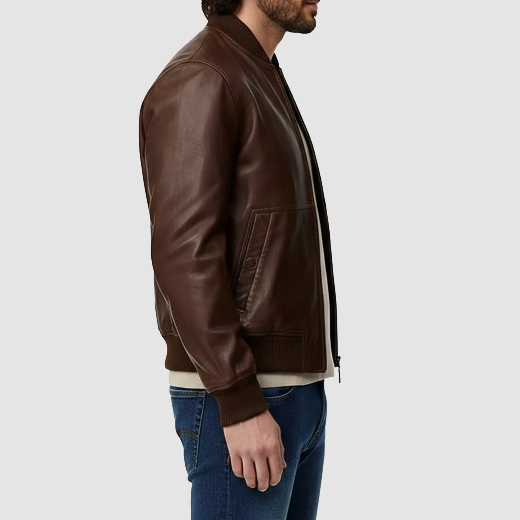 Men-wearing-brown-leather-bomber-jacket-styled-with-jeans-and-boots-walking-outdoors-in-casual-outfit.