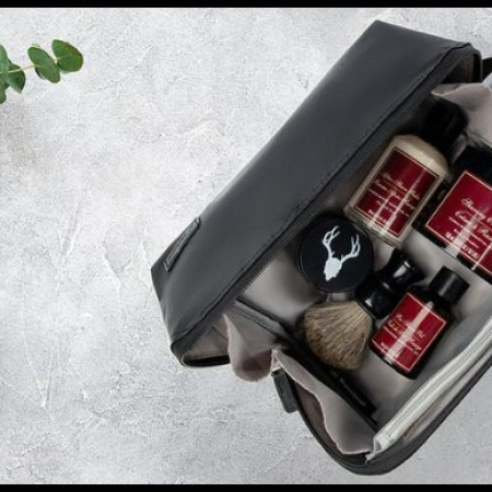 Leather Dopp kit with toiletries for travel, showing organization compartments